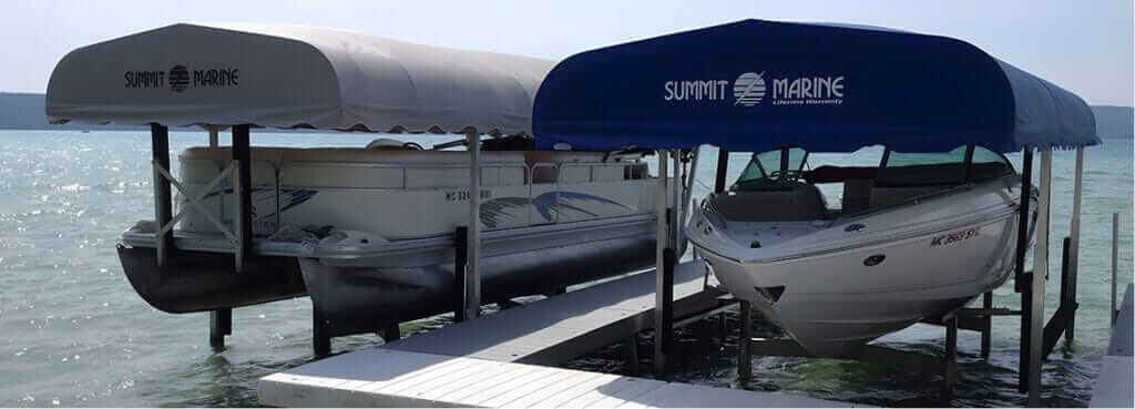 Boat dock with two covered boats at Summit Marine marina.